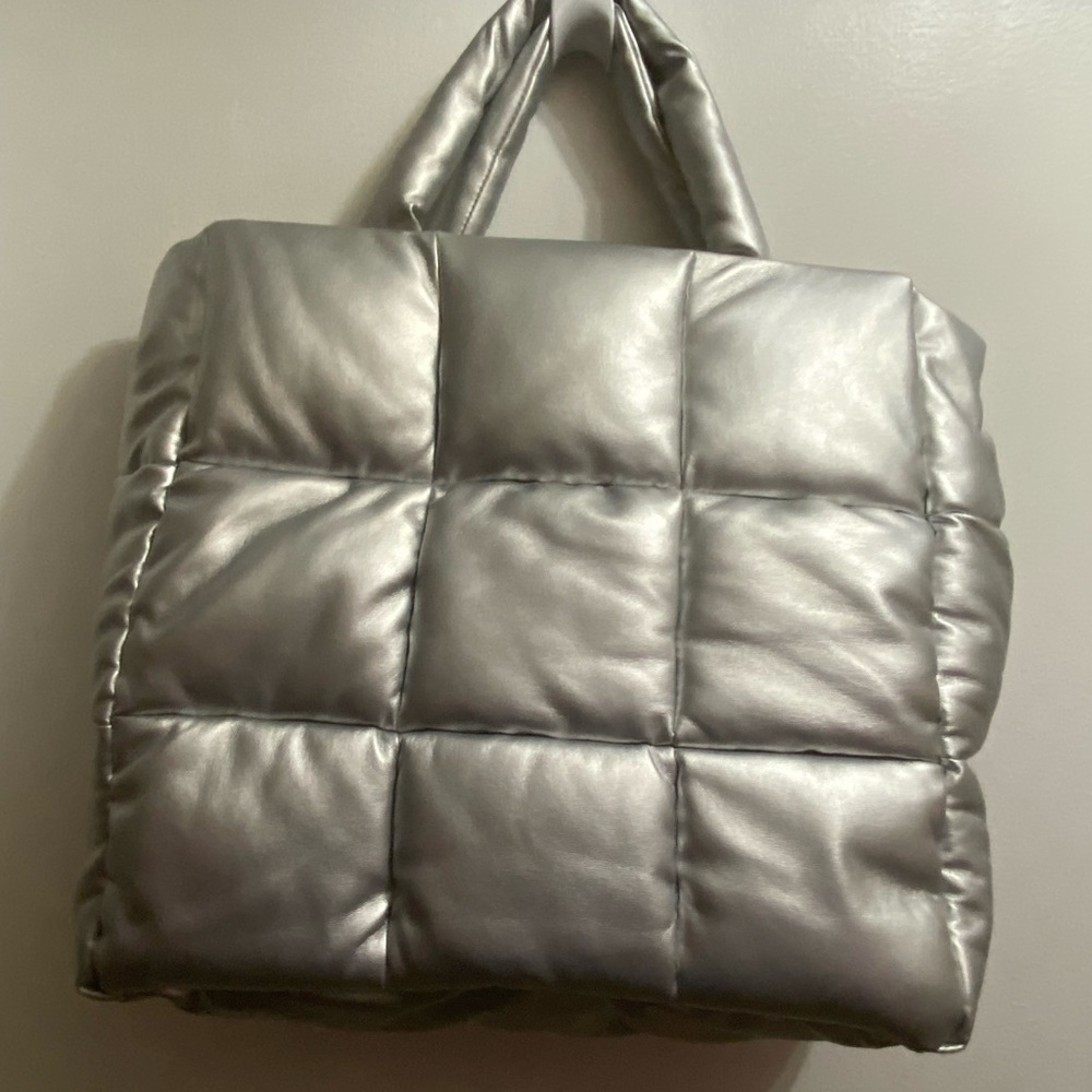 Large vegan leather silver puffer tote with removable shoulder strap.